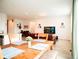 Open-concept living and dining area with light wood floors and bright, neutral paint at 121 S Vandriver Way, Aurora, CO 80018