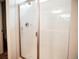 Walk-in shower featuring new tile, a showerhead and glass door at 121 S Vandriver Way, Aurora, CO 80018