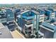 Stunning aerial view of a modern, multi-story home in a vibrant neighborhood with city views in the distance at 6791 Navajo Ct, Denver, CO 80221