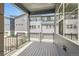 Outdoor balcony with wood floor and dark metal railings overlooking the neighborhood at 6791 Navajo Ct, Denver, CO 80221