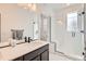 Bathroom boasts modern fixtures, large mirror and a glass shower with bench at 6791 Navajo Ct, Denver, CO 80221