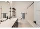 Bathroom boasts modern fixtures, shelving, and a shower and tub combination at 6791 Navajo Ct, Denver, CO 80221