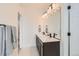 Bathroom boasts double sinks, modern fixtures, and a large mirror at 6791 Navajo Ct, Denver, CO 80221