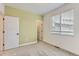 Neutral bedroom features plush carpet, large window and a large closet at 6791 Navajo Ct, Denver, CO 80221