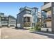 Modern townhome with stylish architecture, blue and white color scheme, and well-maintained landscaping at 6791 Navajo Ct, Denver, CO 80221