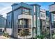 Blue modern townhome with a balcony and contemporary architectural details at 6791 Navajo Ct, Denver, CO 80221