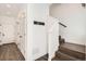 Inviting hallway featuring hardwood floors, modern lighting, and access to the staircase at 6791 Navajo Ct, Denver, CO 80221