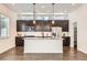 Stylish kitchen featuring dark wood cabinets, stainless appliances, and a center island at 6791 Navajo Ct, Denver, CO 80221