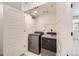 Conveniently located laundry room features a side-by-side washer and dryer at 6791 Navajo Ct, Denver, CO 80221