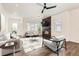 Modern living room with a fireplace, comfortable seating, and plenty of natural light at 6791 Navajo Ct, Denver, CO 80221