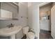 Half bathroom with pedestal sink and neutral finishes at 9602 Indian Wells Dr, Lone Tree, CO 80124