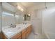 Bathroom featuring a double sink vanity, bright lighting, and tile flooring at 9602 Indian Wells Dr, Lone Tree, CO 80124