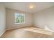 A bright bedroom featuring light hardwood floors, a window, and neutral wall colors at 9602 Indian Wells Dr, Lone Tree, CO 80124