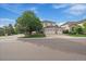Charming two-story home boasts a three-car garage and a well-manicured front lawn, complemented by mature trees at 9602 Indian Wells Dr, Lone Tree, CO 80124