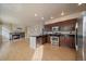 Open concept kitchen with stainless steel appliances and breakfast bar at 9602 Indian Wells Dr, Lone Tree, CO 80124