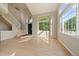 Welcoming living area with soaring ceilings, large windows, and a staircase creating an open and airy atmosphere at 9602 Indian Wells Dr, Lone Tree, CO 80124
