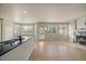 Open-concept space with a kitchen island, fireplace, and an abundance of natural light from many windows at 9602 Indian Wells Dr, Lone Tree, CO 80124