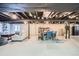 Finished basement features an open layout, painted ceiling, living area, and dining space for versatile living and entertaining at 1851 S Marshall Cir, Lakewood, CO 80232