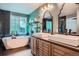 Stylish bathroom features a modern soaking tub, double vanity and a decorative mirror at 1851 S Marshall Cir, Lakewood, CO 80232