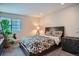 Cozy bedroom with wood-framed bed, floral bedding, wood flooring, and natural light at 1851 S Marshall Cir, Lakewood, CO 80232