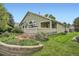 Landscaped backyard of the home featuring a stone garden, green grass, and back deck perfect for outdoor enjoyment at 1851 S Marshall Cir, Lakewood, CO 80232