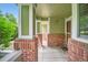 Covered front porch with brick pillars provides a cozy outdoor space at 1851 S Marshall Cir, Lakewood, CO 80232