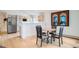 Bright eat-in kitchen boasts stainless steel appliances, light wood floors and a decorative painting at 1851 S Marshall Cir, Lakewood, CO 80232