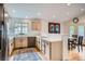 Updated kitchen with stainless appliances, white cabinets and backsplash, and a dining area at 1851 S Marshall Cir, Lakewood, CO 80232