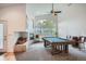 Bright living room with a pool table, fireplace, and large windows at 1851 S Marshall Cir, Lakewood, CO 80232