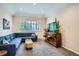 Bright living room features plush blue sectional sofa, modern furniture, and a tray ceiling at 1851 S Marshall Cir, Lakewood, CO 80232