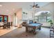 Open-concept living room features a pool table, fireplace, and dining area at 1851 S Marshall Cir, Lakewood, CO 80232