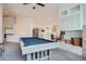 Spacious living room with a fireplace, pool table, and vaulted ceilings at 1851 S Marshall Cir, Lakewood, CO 80232