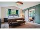 Comfortable main bedroom features a large window and adjoining bathroom with a sliding barn door at 1851 S Marshall Cir, Lakewood, CO 80232