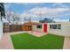 Cozy backyard featuring synthetic grass, a pergola, and access to the back door at 3800 Umatilla St, Denver, CO 80211