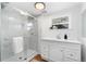 Bright bathroom showcasing a glass enclosed shower and updated vanity at 3800 Umatilla St, Denver, CO 80211