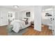 Bedroom with adjacent office and bathroom, providing convenience and comfort at 3800 Umatilla St, Denver, CO 80211