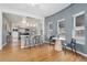 Bright dining area with modern chairs, sleek table, and kitchen view at 3800 Umatilla St, Denver, CO 80211