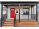 Inviting front porch with stylish railings and a vibrant red front door at 3800 Umatilla St, Denver, CO 80211