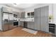 Modern kitchen features stainless steel appliances and light gray cabinetry at 3800 Umatilla St, Denver, CO 80211