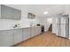 Stylish kitchen boasts gray cabinets, stainless steel appliances, and subway tile backsplash at 3800 Umatilla St, Denver, CO 80211