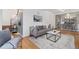 Comfortable living room with a cozy sofa, stylish rug, and staircase view at 3800 Umatilla St, Denver, CO 80211