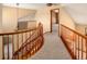 Second floor hallway overlooking the curved staircase at 9632 Dolton Ct, Highlands Ranch, CO 80126