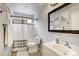 Well-lit bathroom featuring a shower-tub combo with curtain, a white vanity, and neutral tile flooring at 13072 Westlake Pl, Broomfield, CO 80020