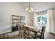 Bright dining room features hardwood floors, vaulted ceiling, modern light fixture and large window at 13072 Westlake Pl, Broomfield, CO 80020