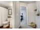 Hallway view into a bathroom and bedroom in a home with updated carpet at 13072 Westlake Pl, Broomfield, CO 80020