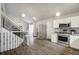 A well-appointed kitchen boasts stainless steel appliances and seamless flow to the staircase at 13072 Westlake Pl, Broomfield, CO 80020