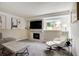 Comfortable living room with fireplace, large window and contemporary decor at 13072 Westlake Pl, Broomfield, CO 80020