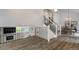 Open-concept living and dining area with sleek flooring and staircase at 13072 Westlake Pl, Broomfield, CO 80020