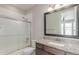 Bathroom with a granite-topped vanity, a large mirror, and a shower with sliding glass doors at 15843 E Broncos Pl, Englewood, CO 80112