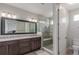 Modern bathroom with a double vanity, granite countertops, and a glass-enclosed shower with seat at 15843 E Broncos Pl, Englewood, CO 80112